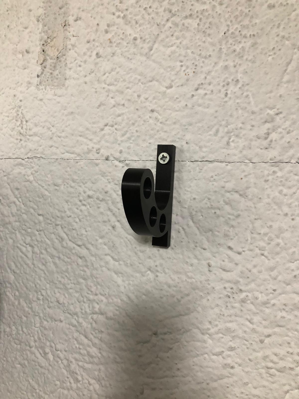 Wall mounted motorcycle helmet holder