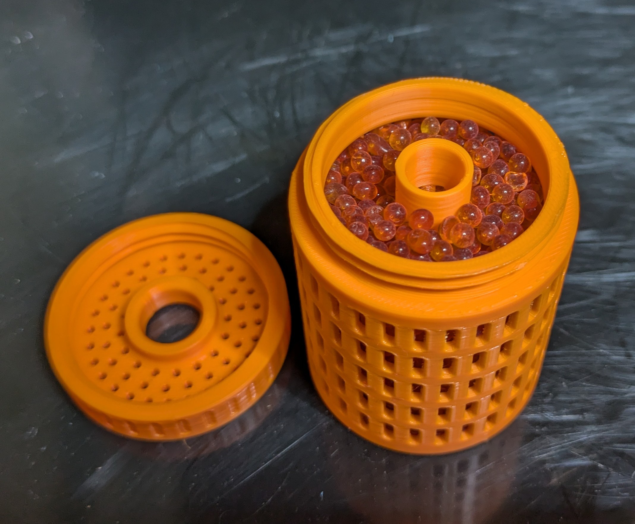 Aerated container for silica gel - Filament spool desiccator